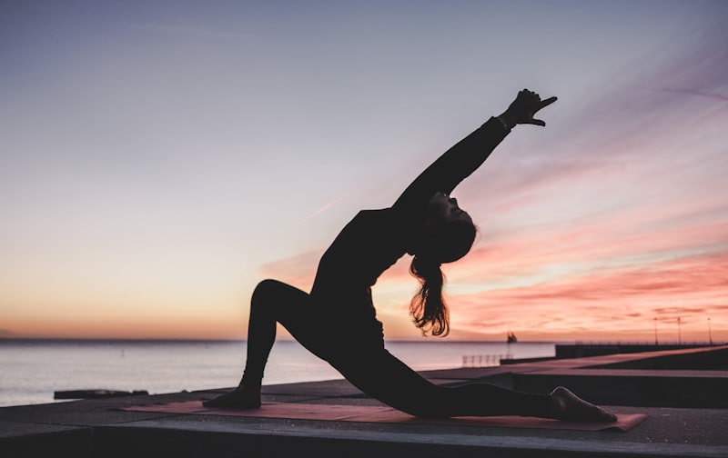 Woman practicing yoga representing holistic wellness
